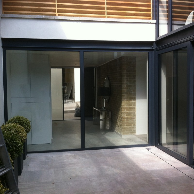 Floor-to-ceiling sliding doors opening to courtyard in Brockley