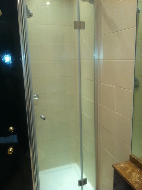 Frameless glass shower enclosure with chrome fittings in Brockley