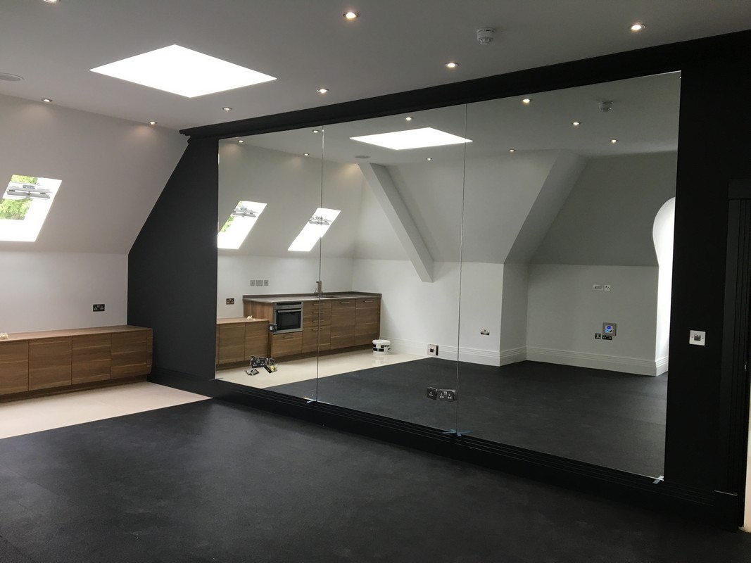 Frameless glass wall dividing loft conversion in Brockley