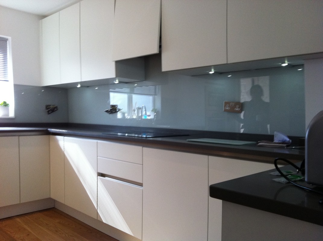Grey glass kitchen splashback with LED lighting in Brockley