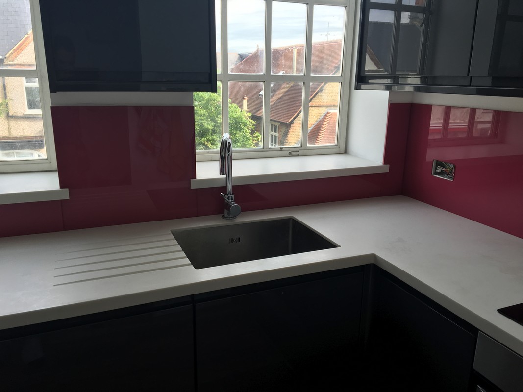 Deep plum coloured glass splashback in modern Brockley kitchen