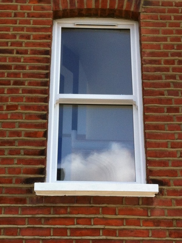 uPVC sash window on Victorian red brick house in Brockley